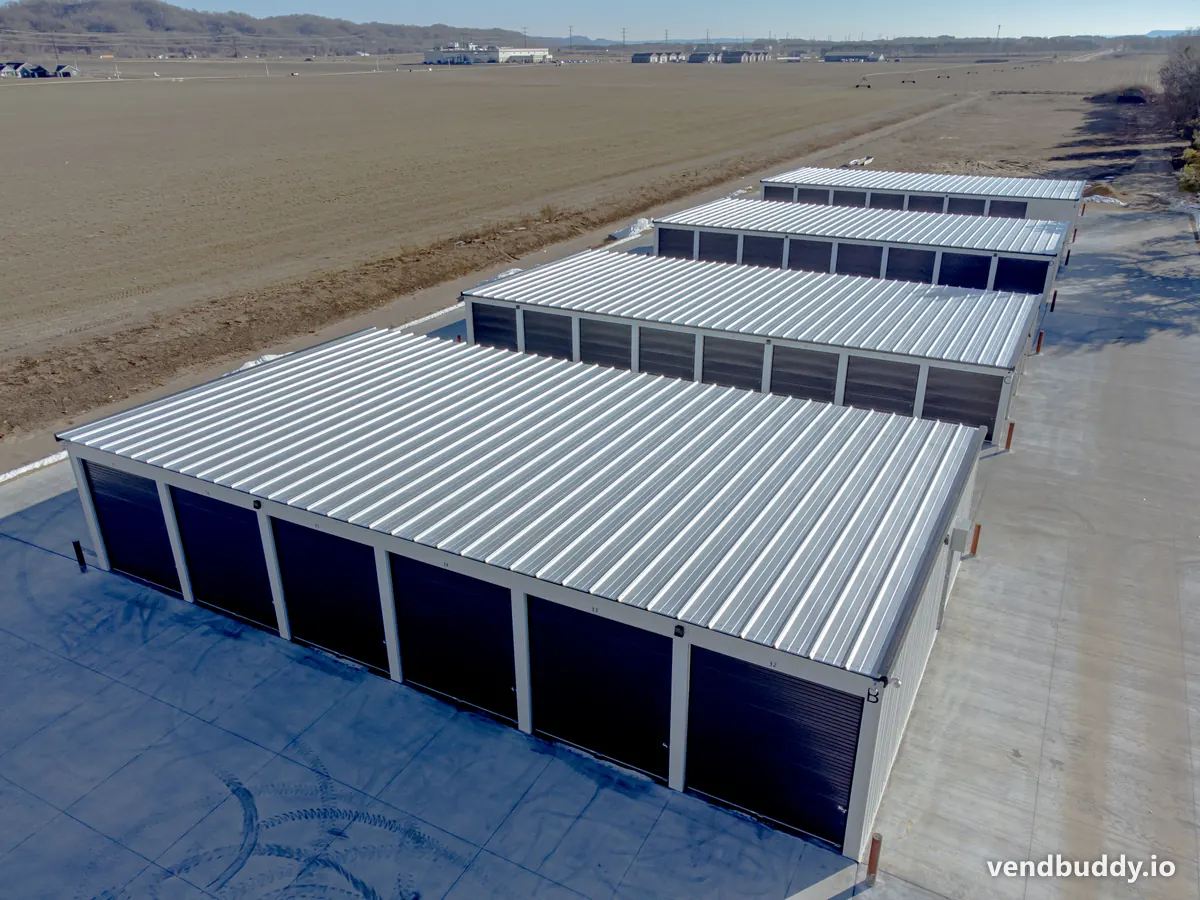 A self storage facility with rows of roll-up doors, a drive-up vending location